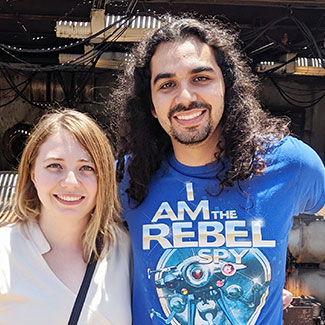 picture of a smiling man and woman with Disneyland in the background